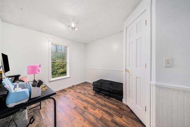 office area featuring dark hardwood / wood-style flooring and a textured ceiling