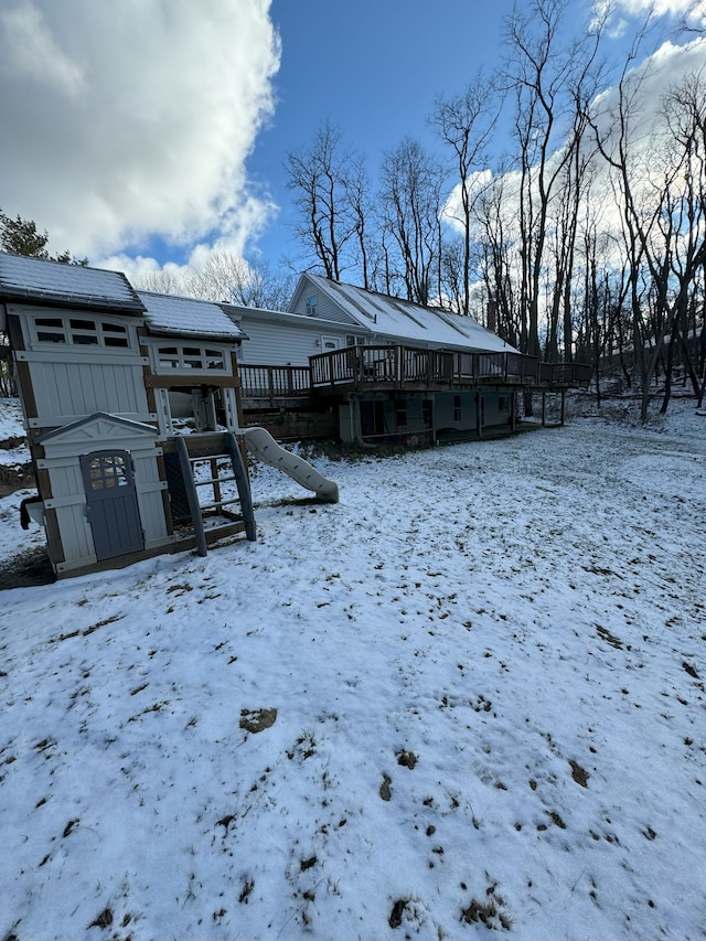 yard layered in snow with a shed and a deck