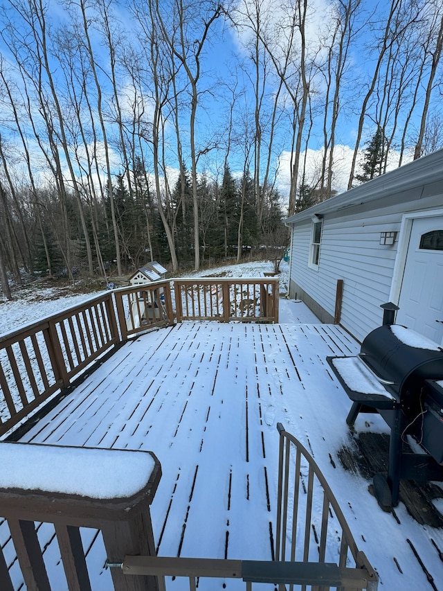 snow covered deck featuring grilling area