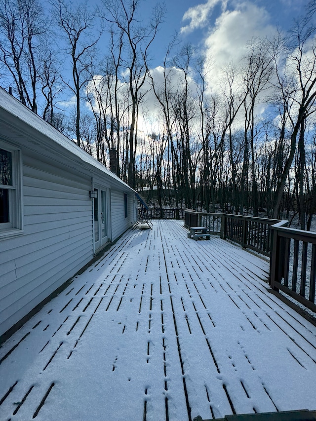 snow covered deck with french doors