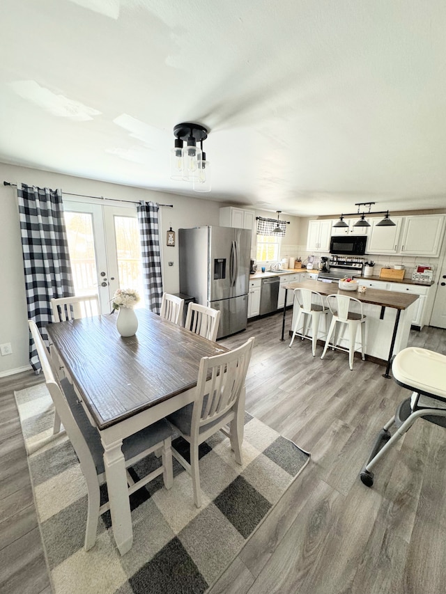 dining area featuring light hardwood / wood-style flooring and french doors