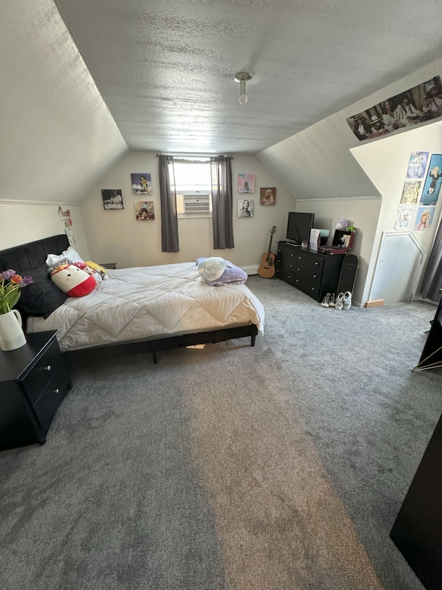 carpeted bedroom with a textured ceiling and vaulted ceiling