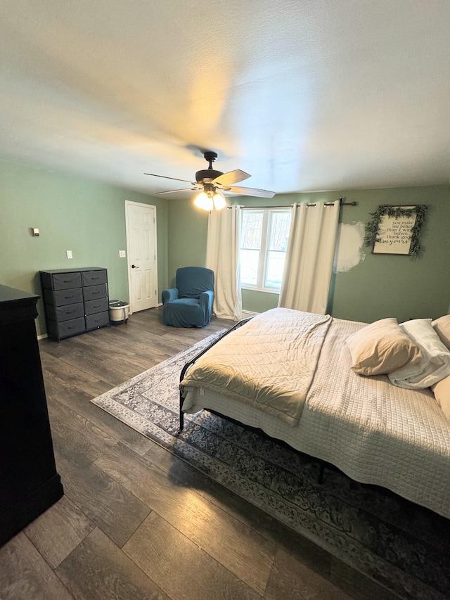 bedroom with ceiling fan and dark hardwood / wood-style floors