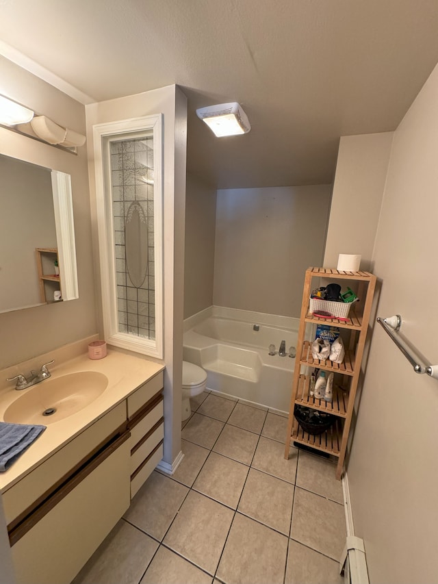 bathroom with tile patterned flooring, vanity, toilet, and a tub