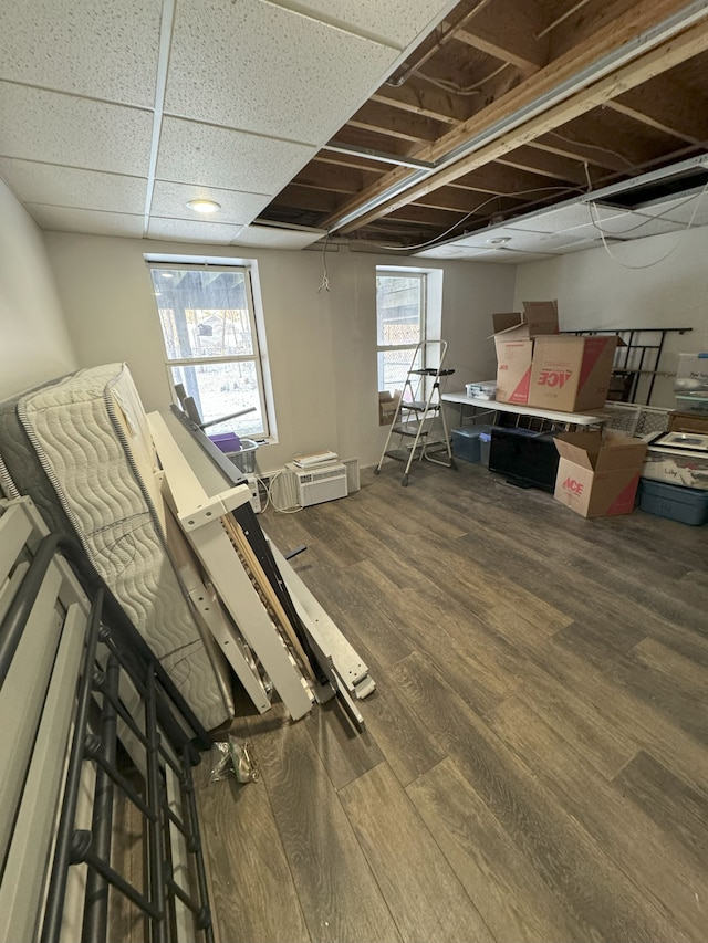 interior space featuring hardwood / wood-style floors and a drop ceiling