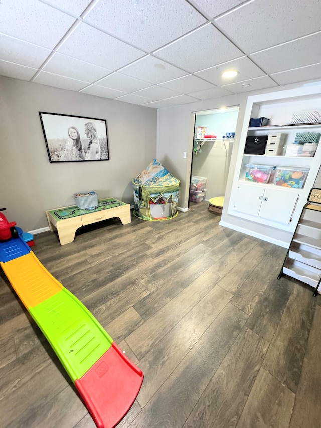 rec room featuring a drop ceiling and dark hardwood / wood-style floors