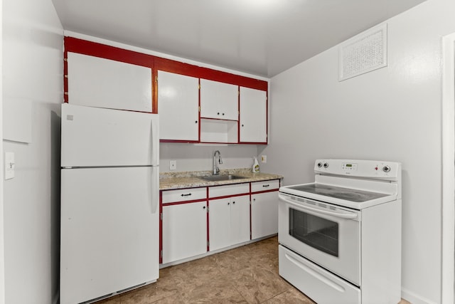 kitchen featuring white cabinetry, white appliances, and sink