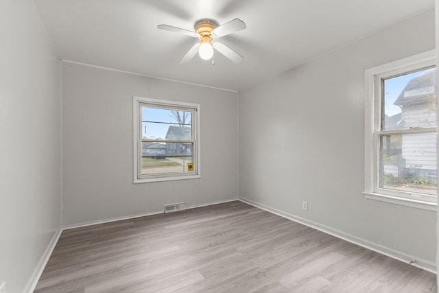 empty room featuring ceiling fan and light hardwood / wood-style flooring