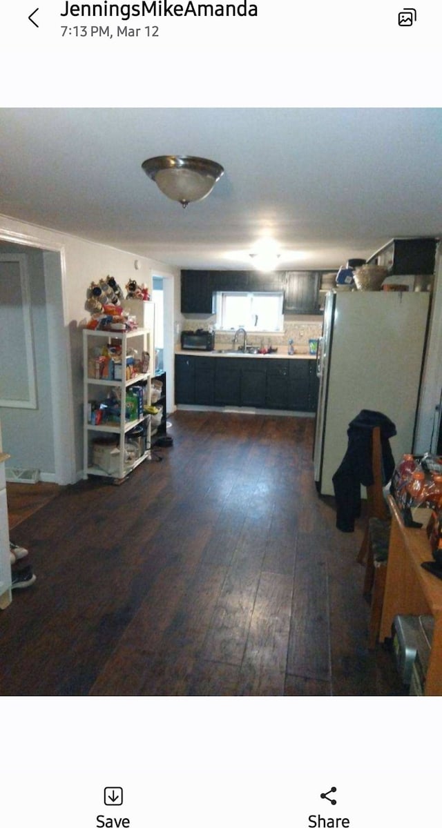 interior space with dark hardwood / wood-style floors and sink