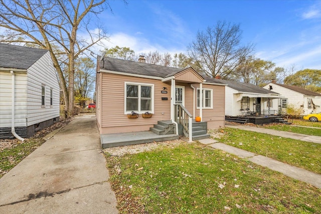 bungalow-style house featuring a front yard