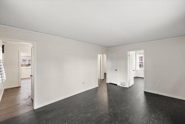 spare room featuring dark wood-type flooring