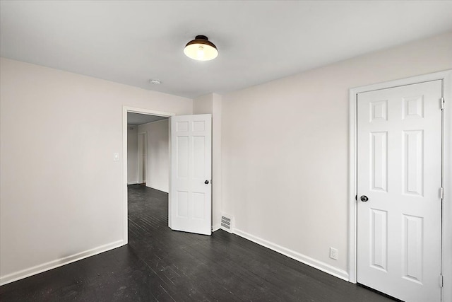 unfurnished room featuring dark hardwood / wood-style floors