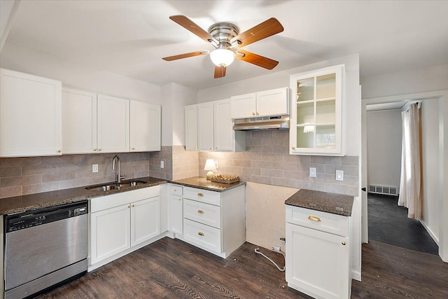 kitchen featuring white cabinets, stainless steel dishwasher, dark wood-type flooring, and dark stone countertops