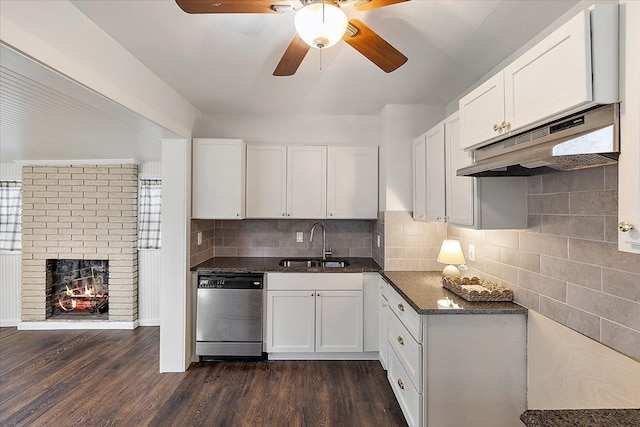 kitchen featuring white cabinetry, sink, dark wood-type flooring, stainless steel dishwasher, and decorative backsplash