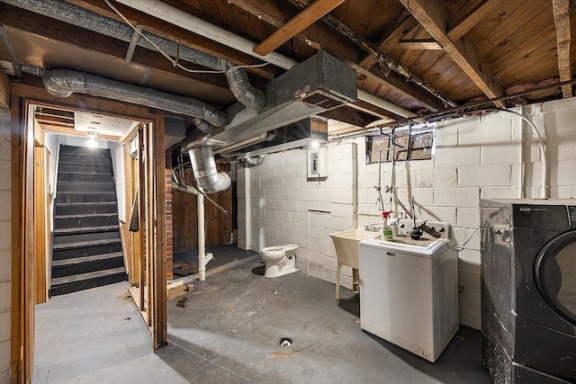 basement featuring sink and washing machine and clothes dryer