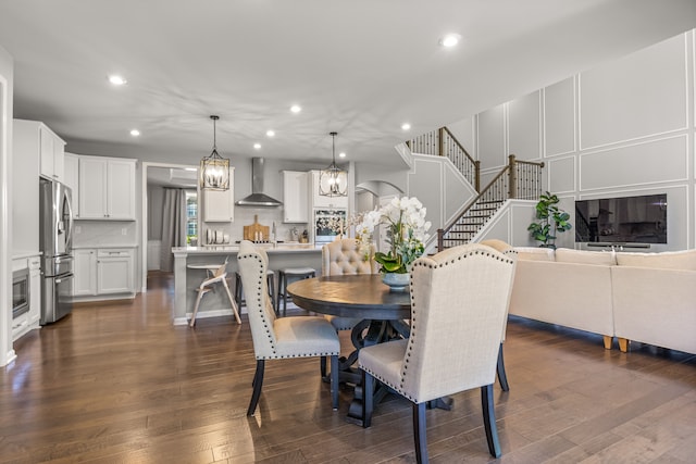 dining area with dark hardwood / wood-style flooring and a notable chandelier