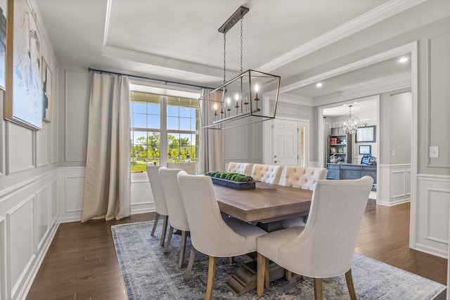 dining area featuring a notable chandelier, ornamental molding, and dark wood-type flooring