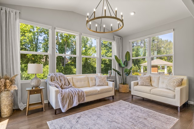 sunroom with an inviting chandelier and lofted ceiling