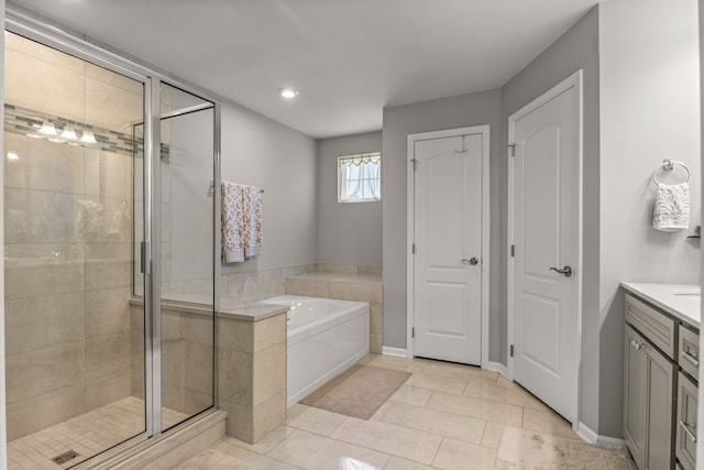 bathroom featuring tile patterned flooring, vanity, and independent shower and bath