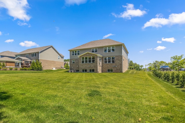 rear view of property with a lawn