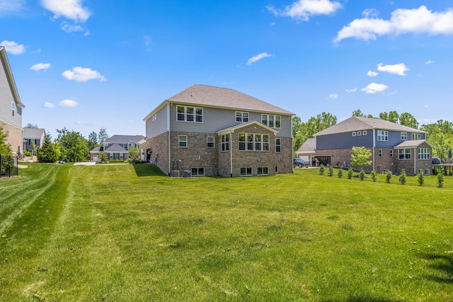 back of house with a lawn