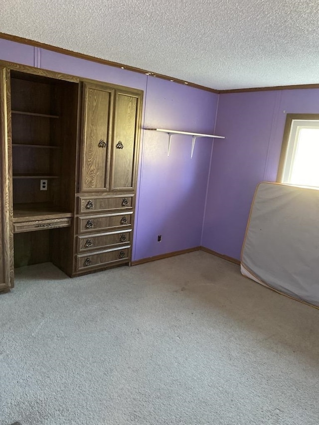 unfurnished bedroom featuring a textured ceiling and light colored carpet