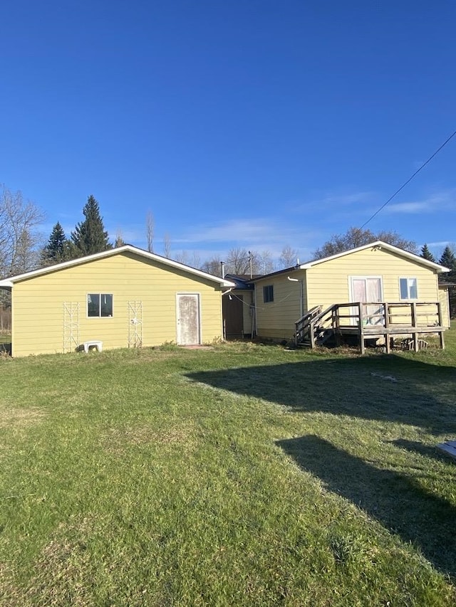 exterior space featuring a lawn and a deck