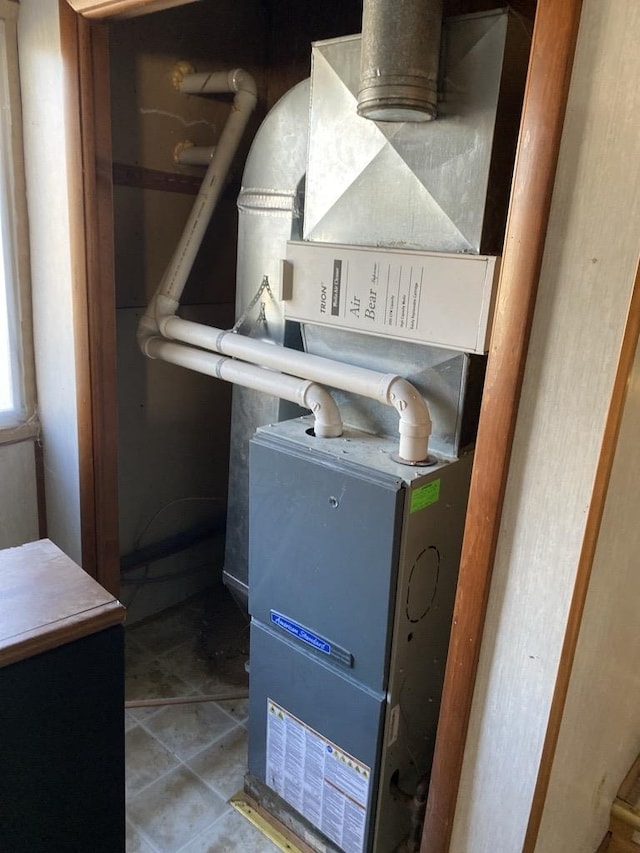 utility room featuring heating unit