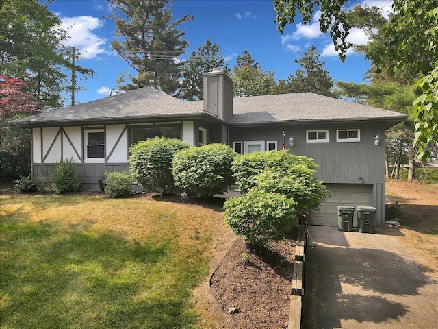 back of property featuring a yard and a garage