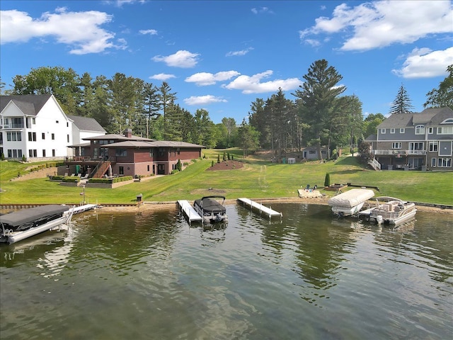 view of dock featuring a yard and a water view