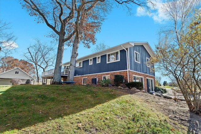 view of side of home with a lawn and a garage