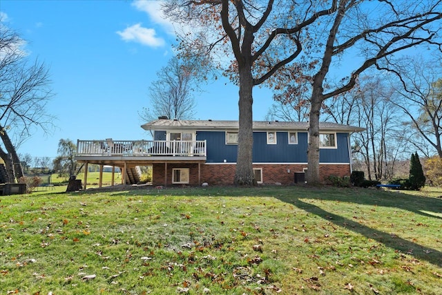 rear view of house with a yard, cooling unit, and a deck