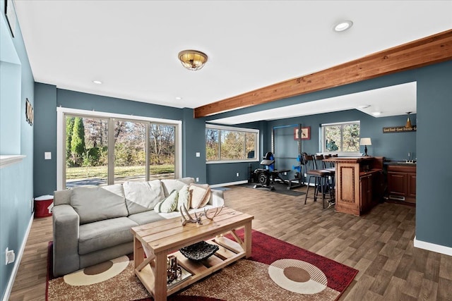 living room featuring beam ceiling and dark wood-type flooring