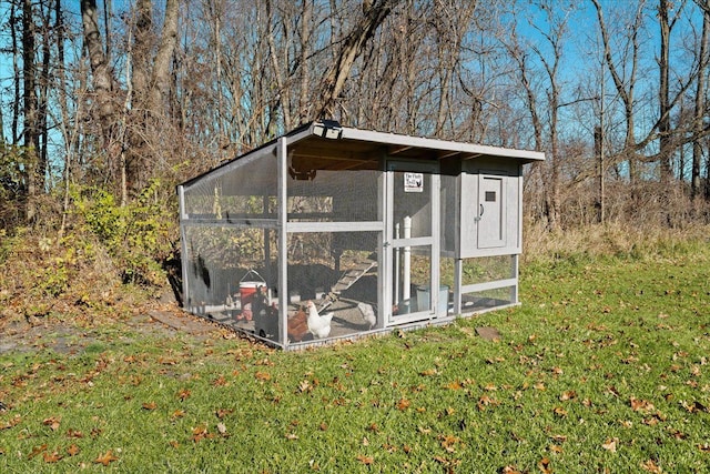 view of outbuilding with a lawn