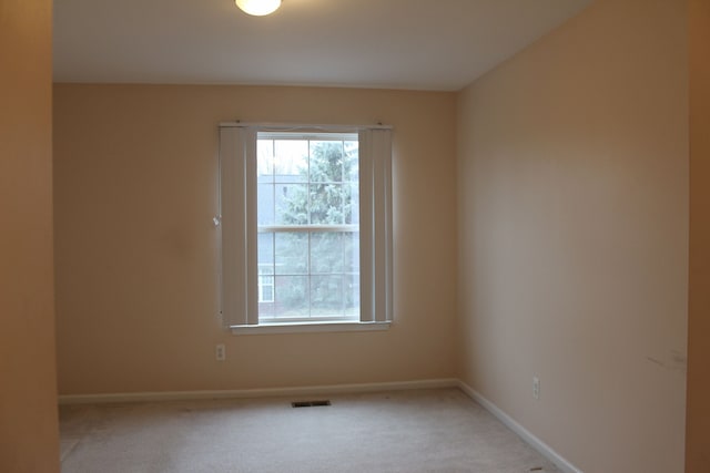 spare room with light colored carpet