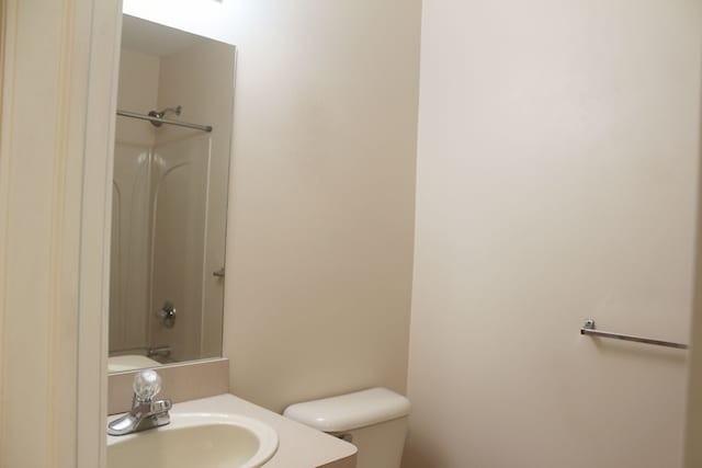 full bathroom featuring bathing tub / shower combination, vanity, and toilet