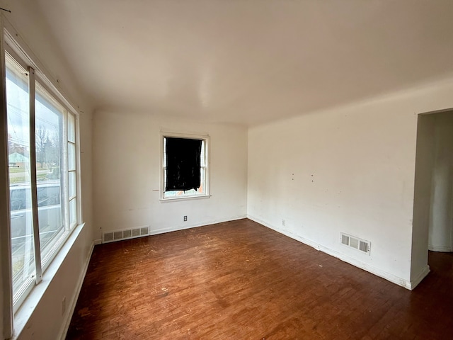 empty room with dark wood-type flooring