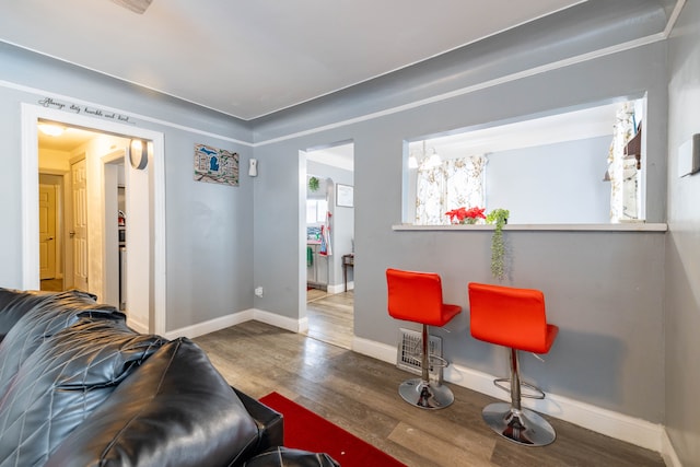 living room with wood-type flooring and an inviting chandelier