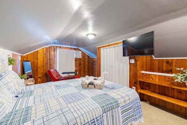 bedroom with wood walls, carpet, and vaulted ceiling