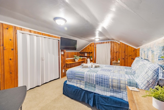 bedroom featuring carpet flooring, wooden walls, and vaulted ceiling