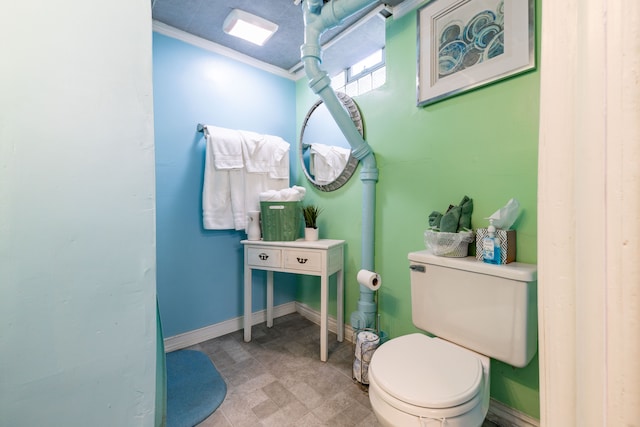 bathroom featuring toilet and ornamental molding