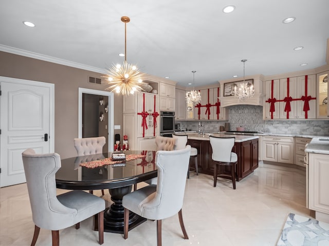 dining area featuring light tile patterned flooring, ornamental molding, sink, and an inviting chandelier