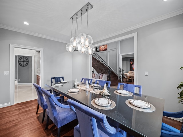 dining area with crown molding, dark wood-type flooring, and a notable chandelier