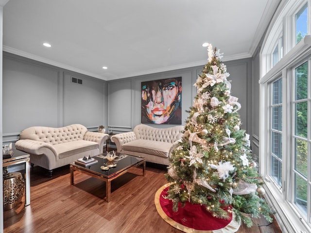 living room with crown molding and wood-type flooring