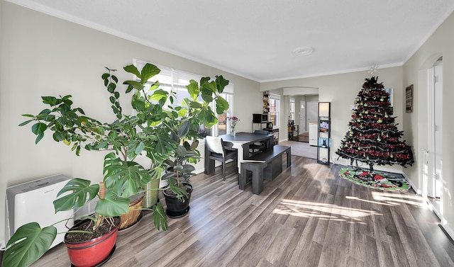 home office featuring hardwood / wood-style flooring and crown molding