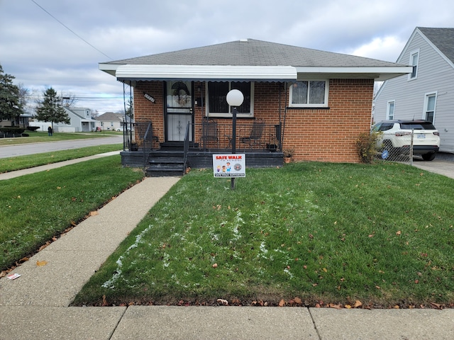 bungalow-style house with a front lawn