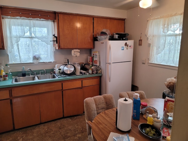 kitchen featuring white refrigerator and sink