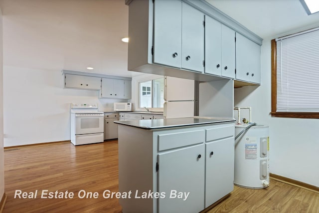 kitchen with white appliances, sink, light hardwood / wood-style floors, and electric water heater