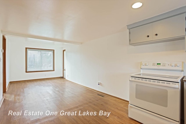 kitchen featuring white electric stove and light wood-type flooring