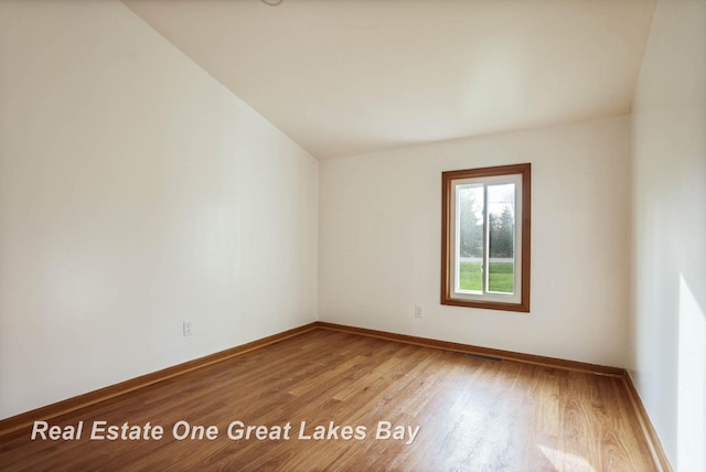 spare room with hardwood / wood-style floors